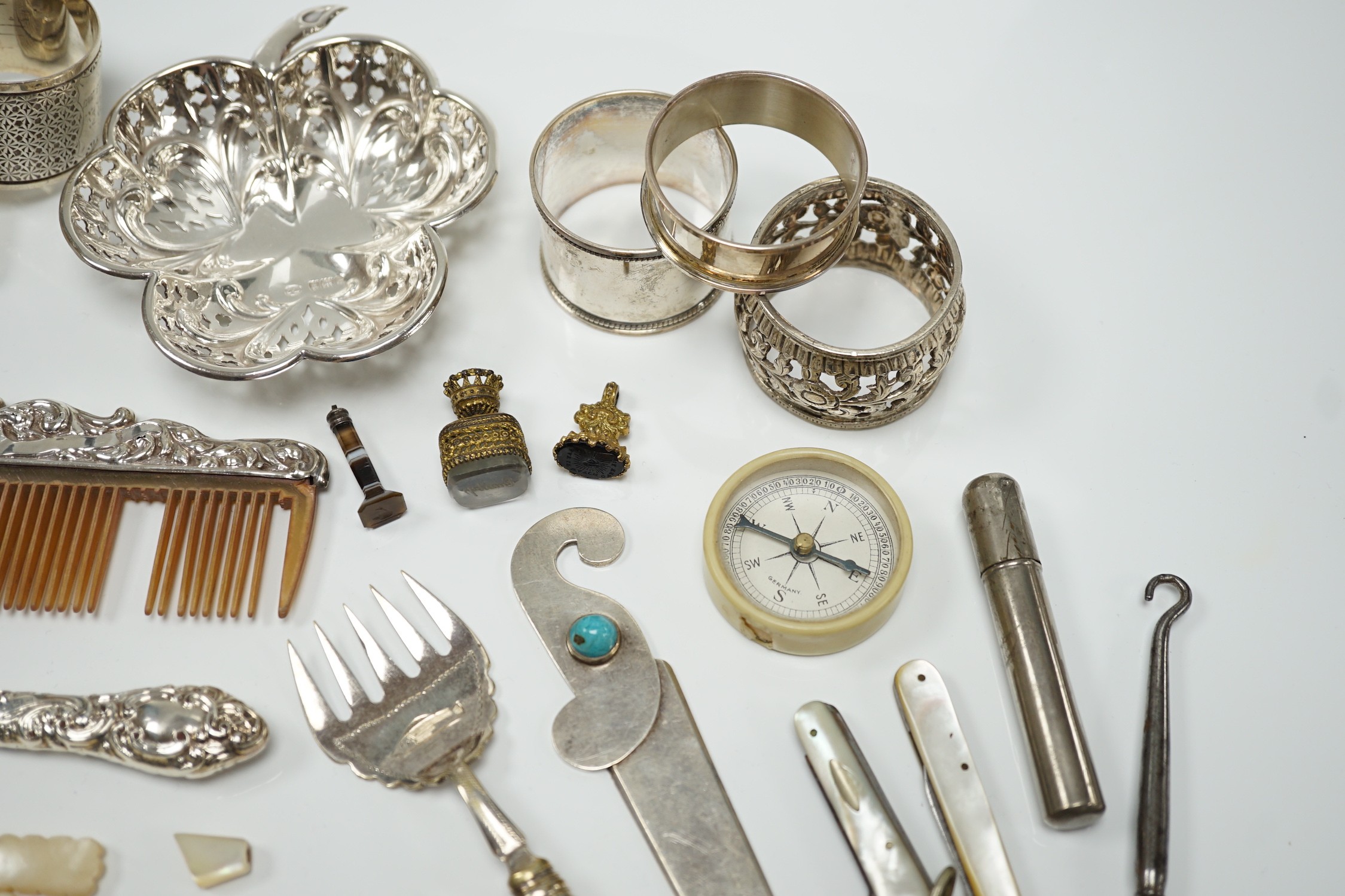 A group of assorted small silver and white metal items, including a small late Victorian clover shaped nut dish, napkin rings, pill box, etc and other items including two gilt metal mounted chalcedony fob seals.